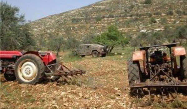 مستعمرون يحرثون أراضي المواطنين في بيت د...