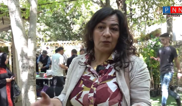 Samah Abu Heikel- A Woman Standing With ...